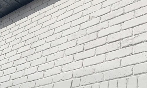 Close-up of classic solid white mineral stained brick