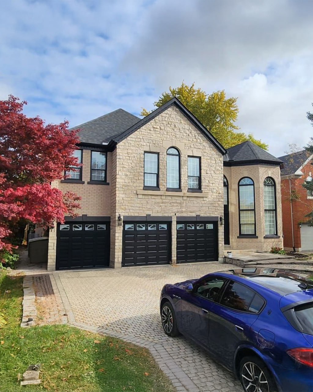Light brick home with black trim showing a classic solid finish