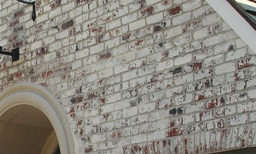 Close-up of European limewash finish on brick masonry