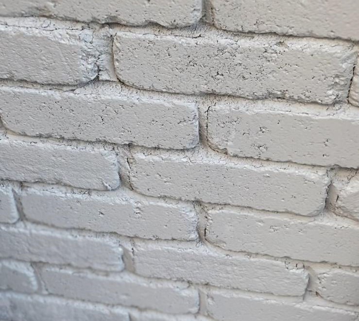 Close-up of light mineral stained brick with visible masonry texture